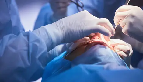 Surgeons performing facial cosmetic procedure